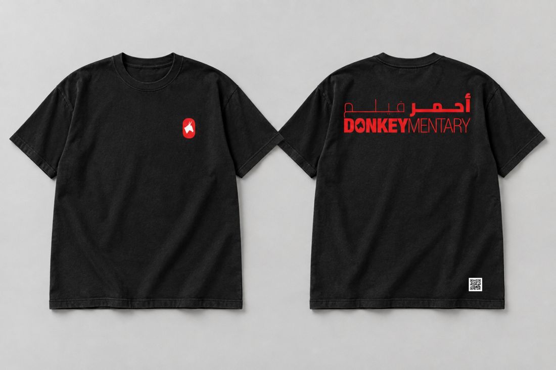 Black T-shirt, front and back: red donkey emblem and red bilingual title.